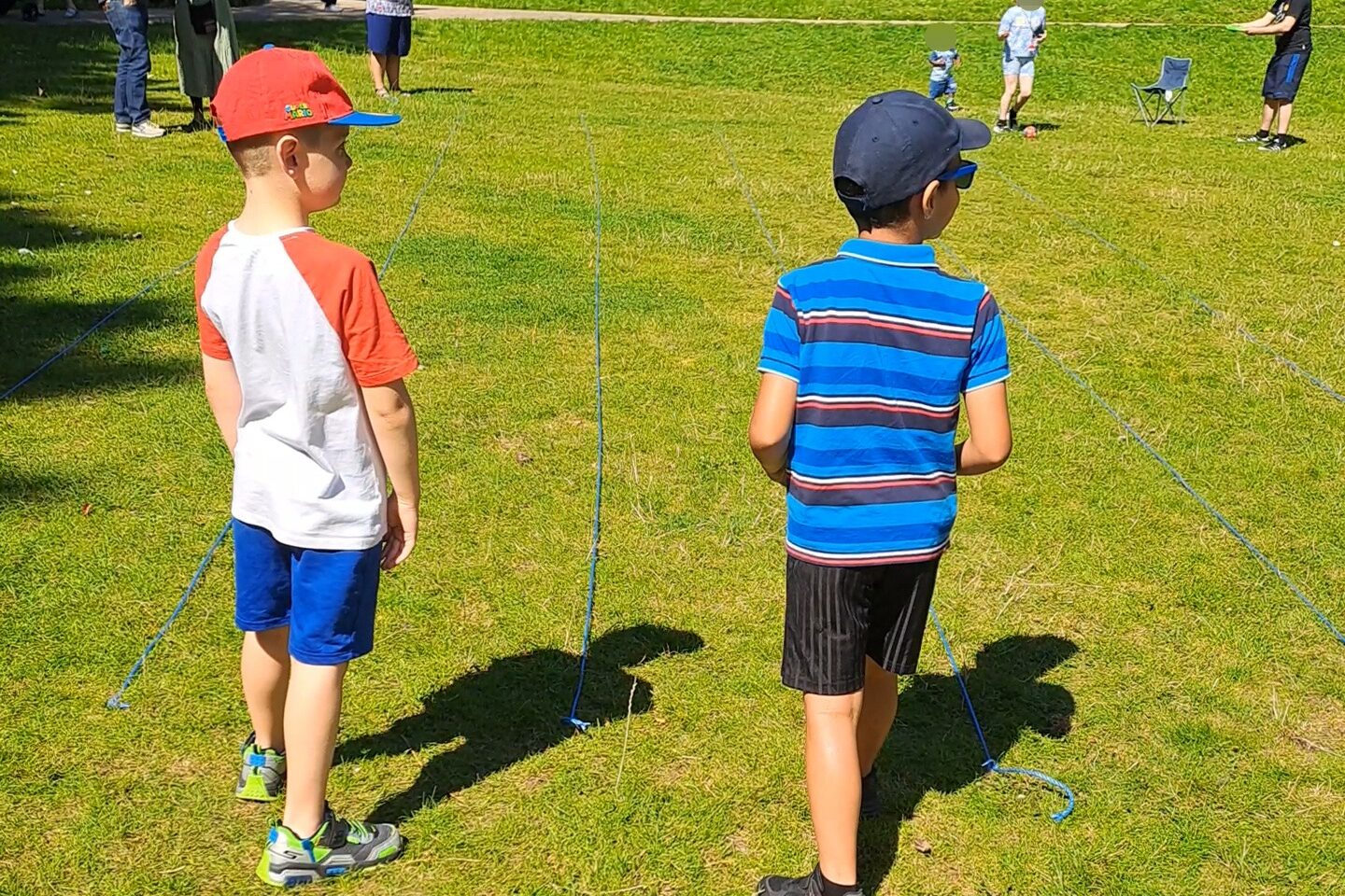 image of 2 boys aged about 6 ready to start racing in Roberts Park. 