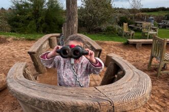 Children playing in the pirate ship in the giant sand playground at Thornwick Bay caravan site, where the Trust has it's caravan for foster families